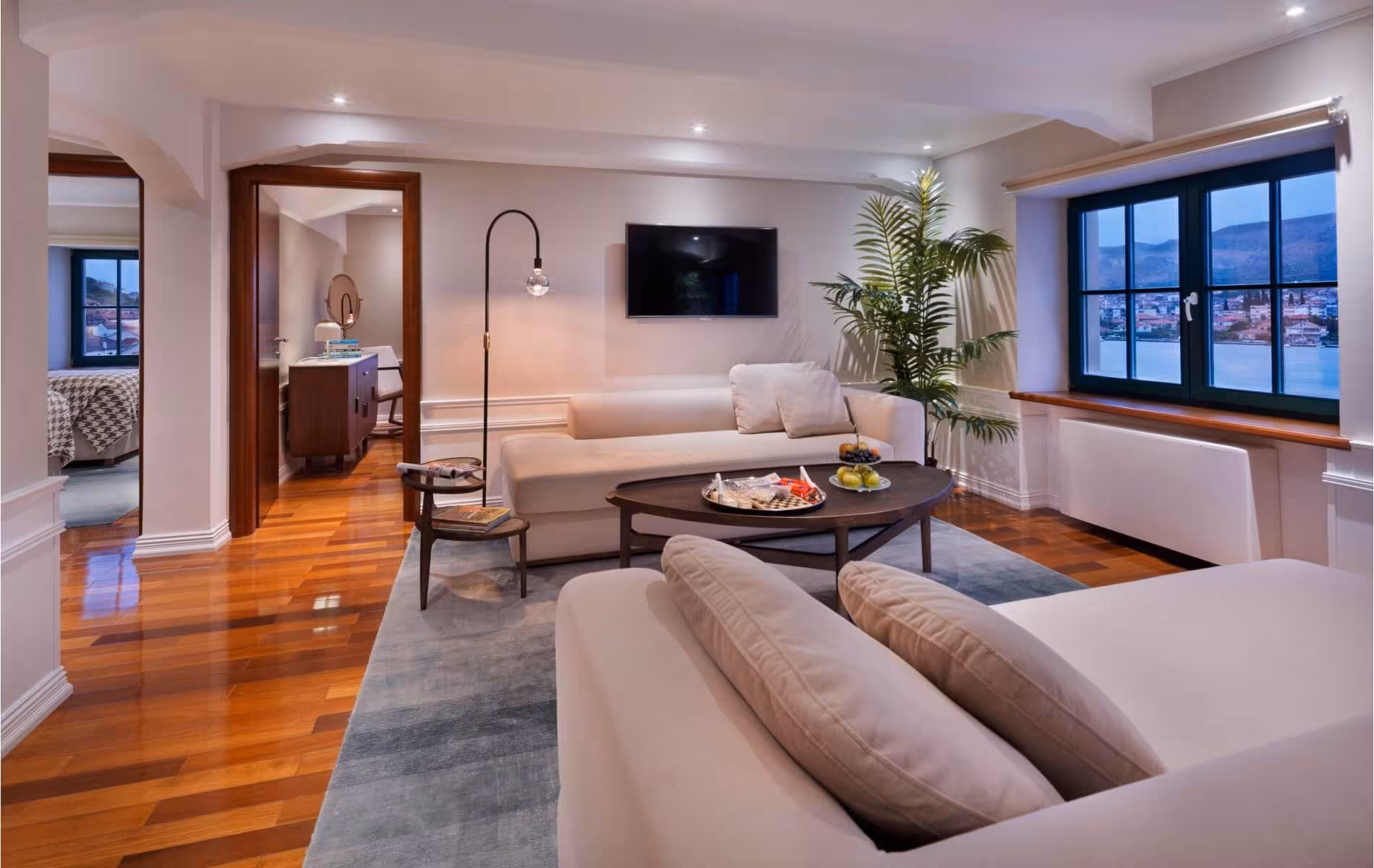 Brown Beach House Design Hotel living area with sofas, coffee table and dark window frames