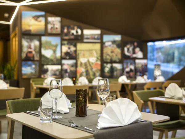 Gospoja restaurant with photo wall and set tables