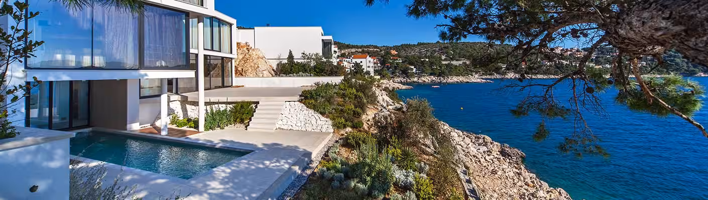 Golden Rays Luxury Resort villa terraces stepping down to the rocky shore