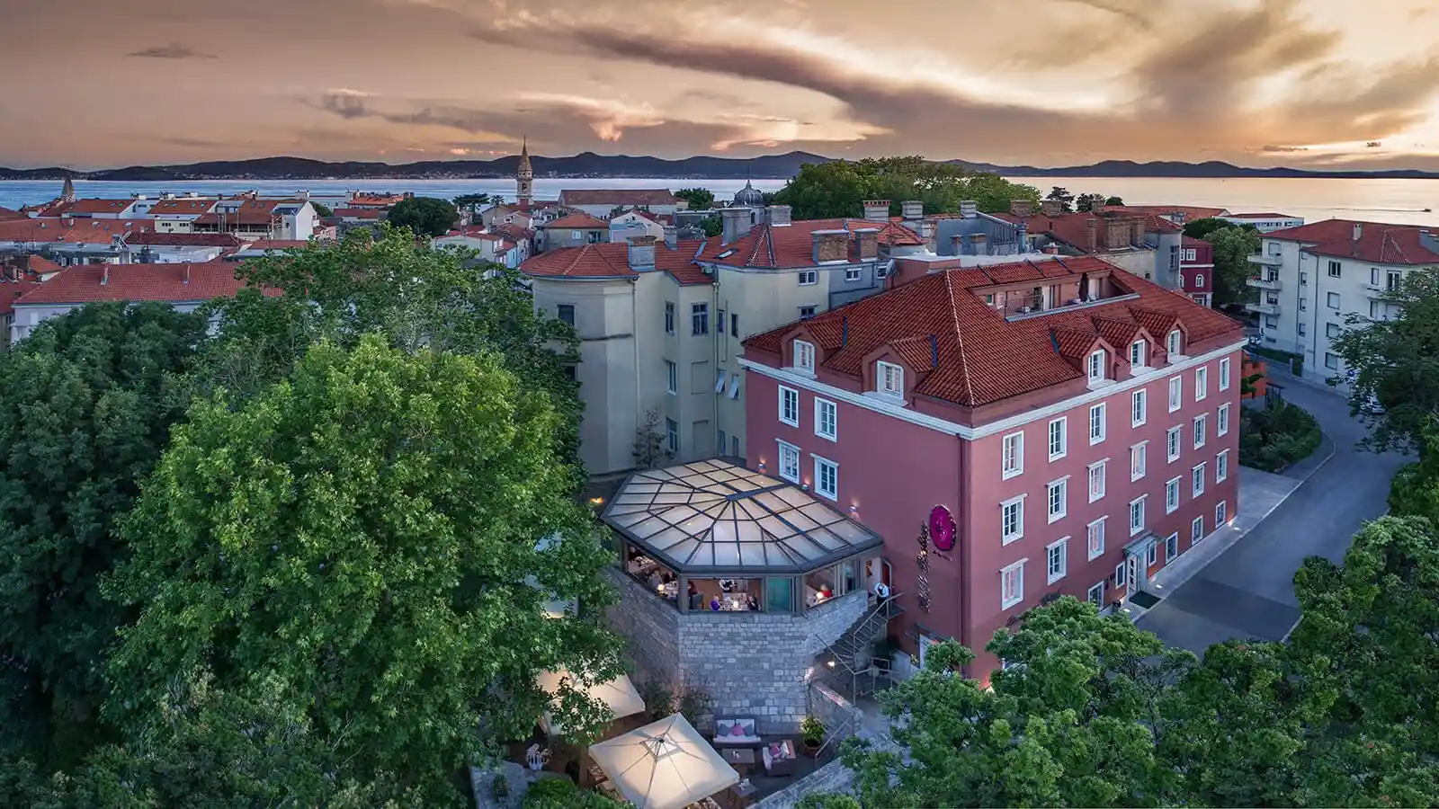 Boutique Hotel Bastion aerial view of the hotel building and town at sunset