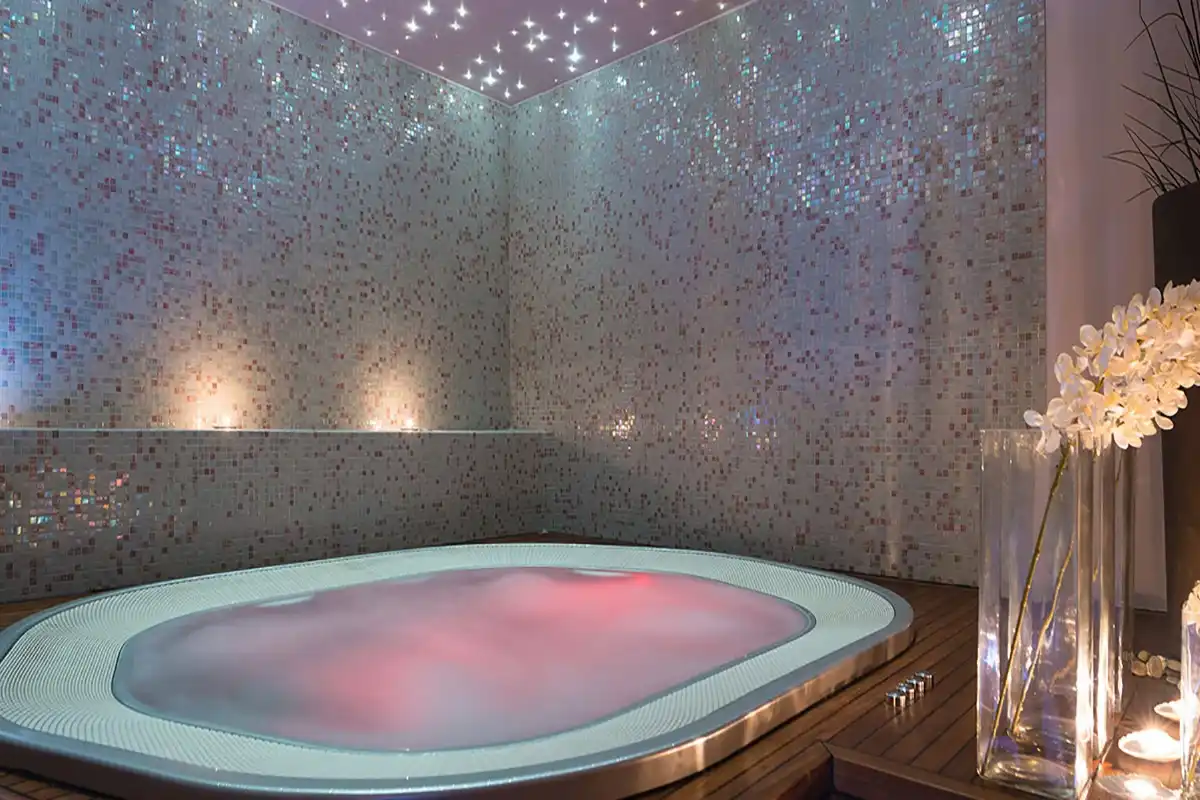 Boutique Hotel Bastion spa hot tub with pink lighting under a starry ceiling