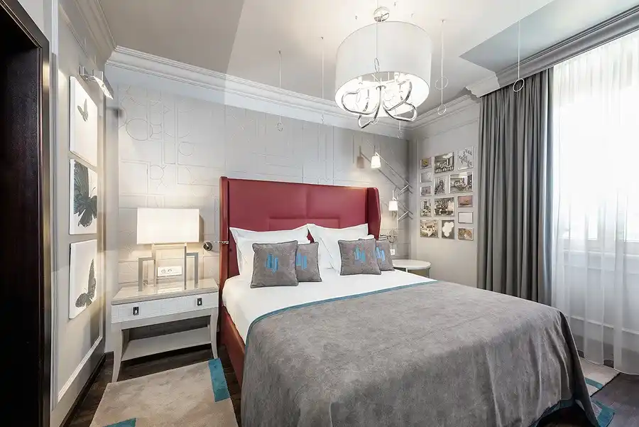 Boutique Hotel Bastion bedroom with red headboard and grey bedspread