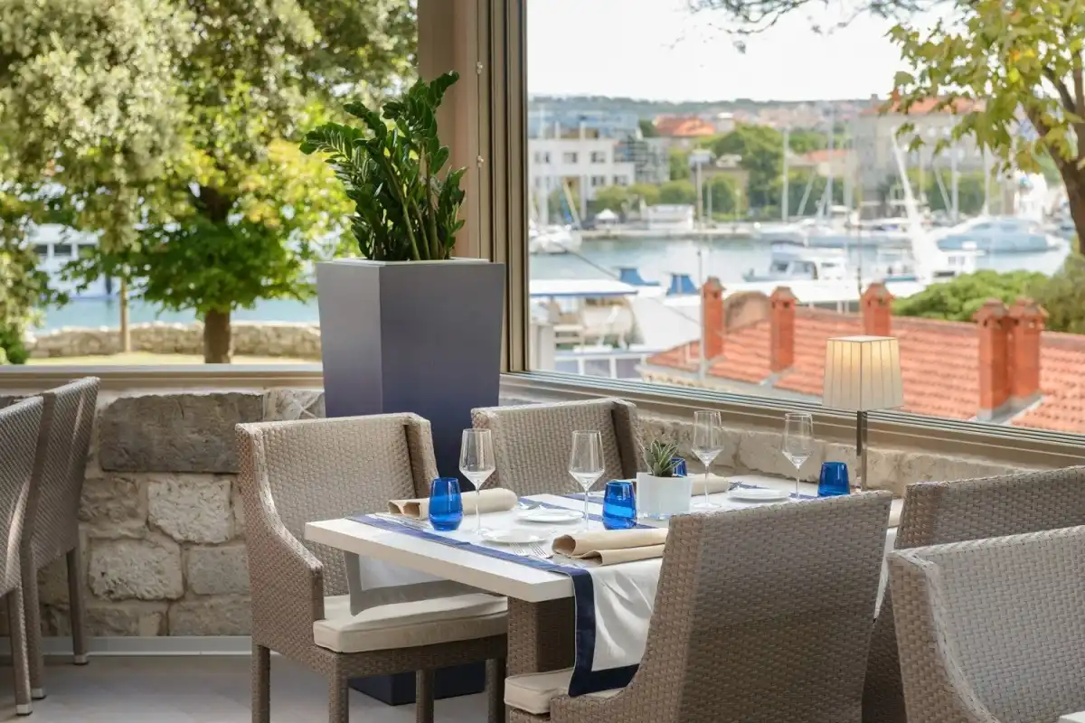 Boutique Hotel Bastion breakfast table by a window overlooking the harbour