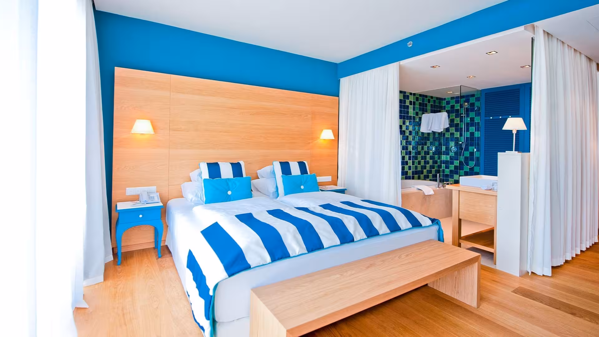 Falkensteiner Hotels Iadera/Senia Apartments suite with blue and white striped bed and wooden wall