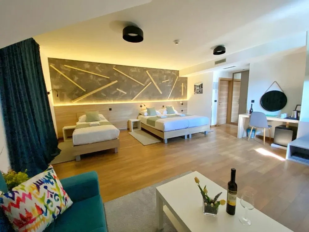 16 Lakes family room with double and single beds and geometric wooden wall