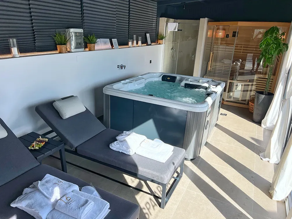16 Lakes private hot tub and sun lounger on a sunny terrace