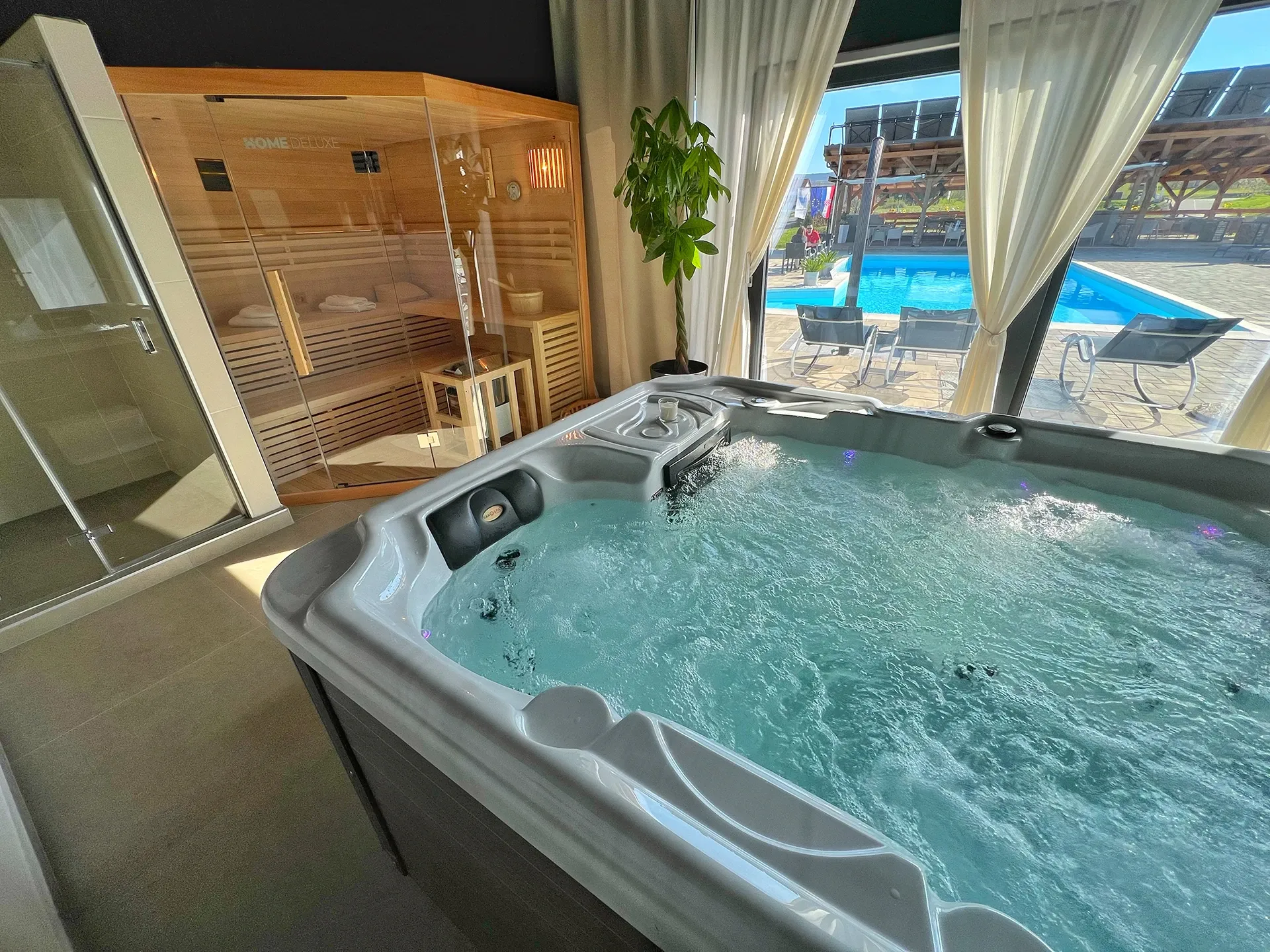 16 Lakes indoor hot tub beside a sauna with garden views