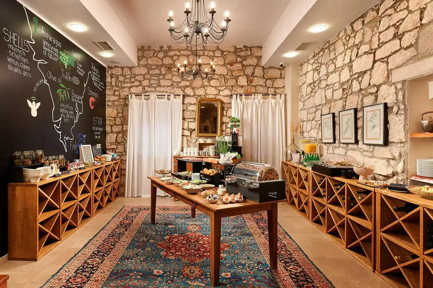 Angelo d'Oro stone-walled breakfast room with chandelier and buffet table