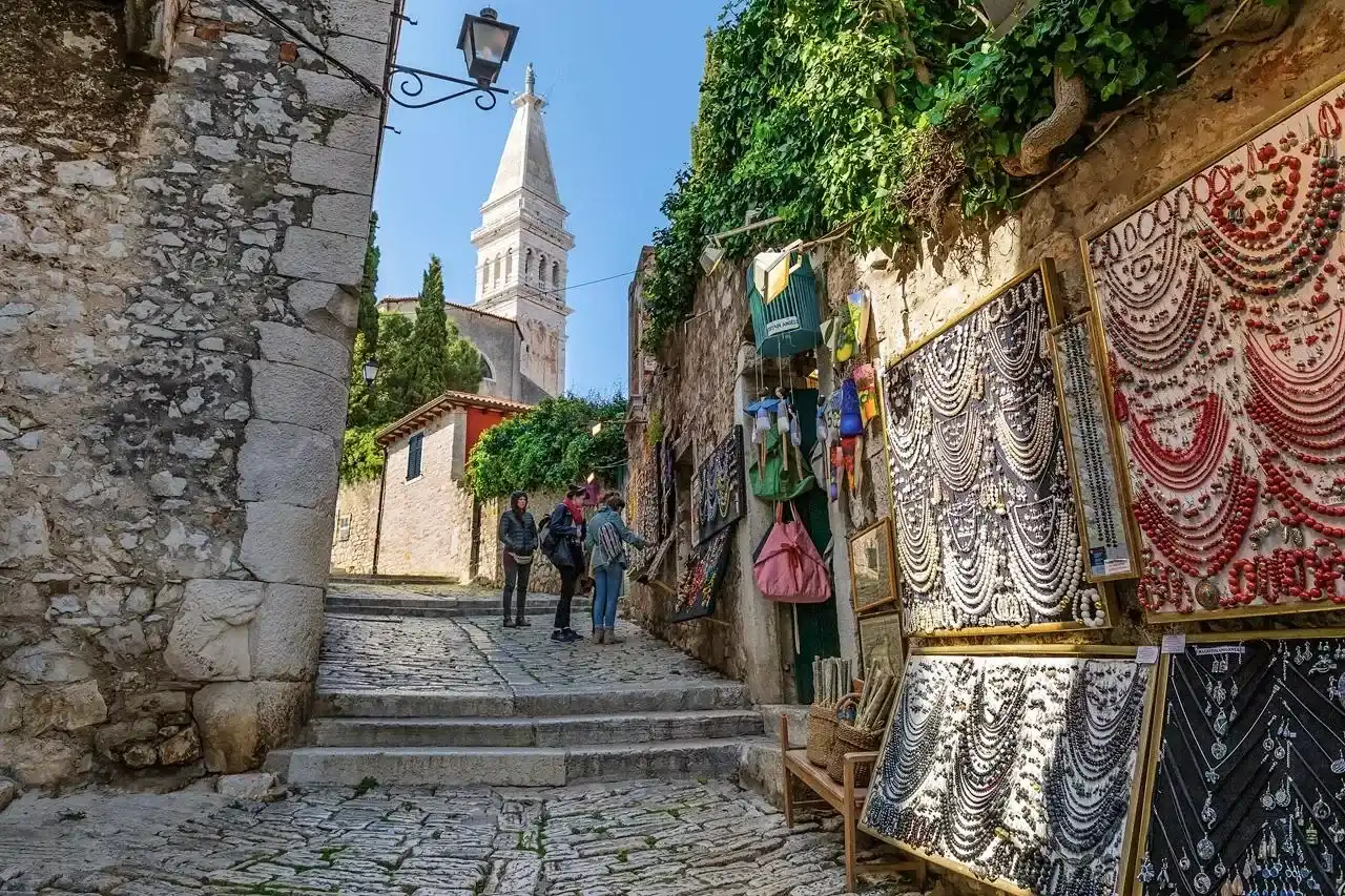 Angelo d'Oro cobbled old town lane with bell tower above