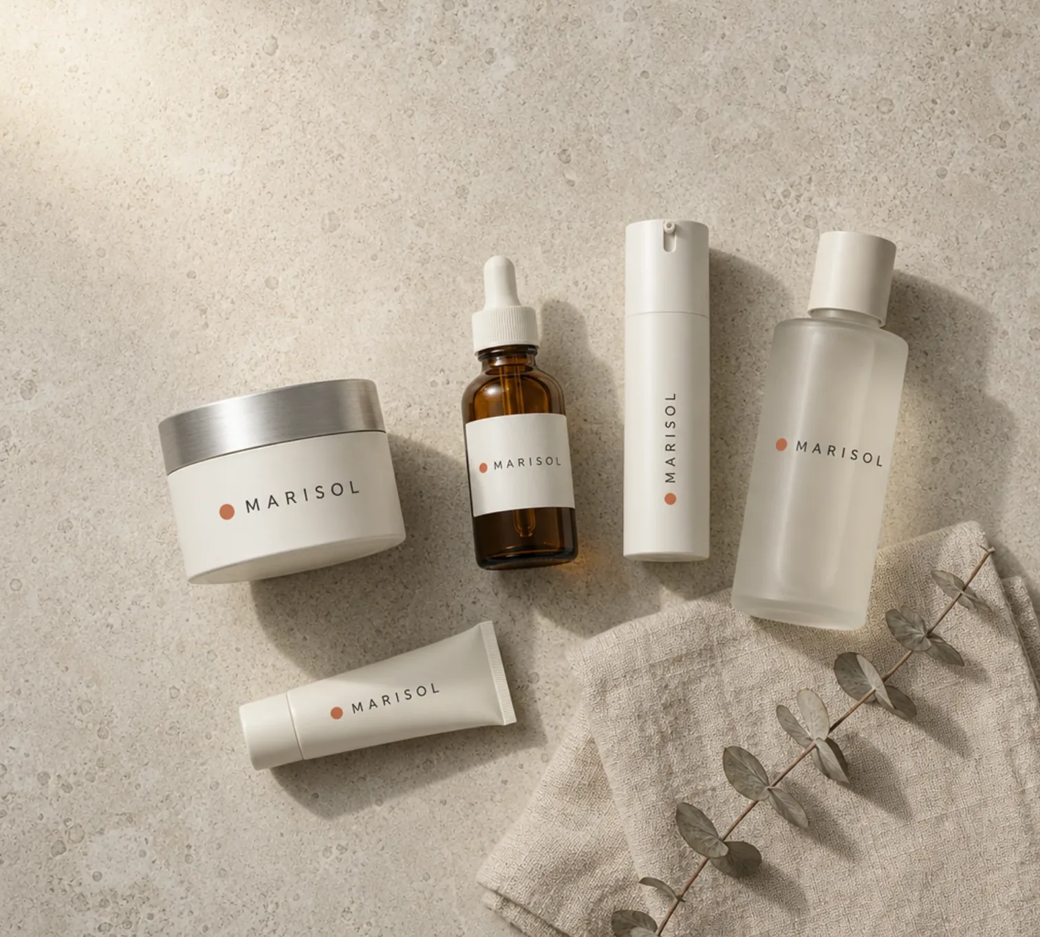Marisol skincare bottles and jars arranged on a beige stone surface