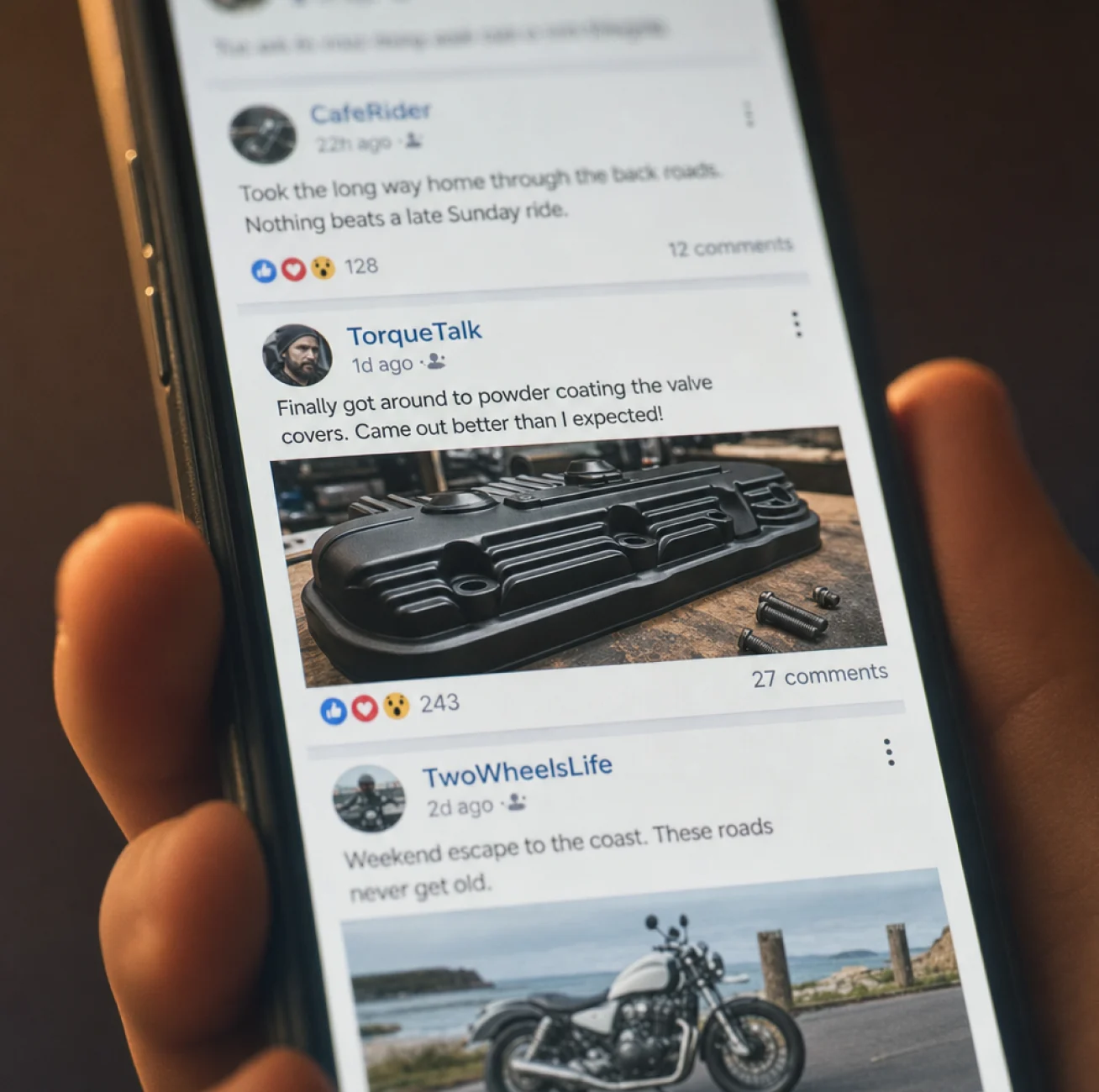Hand holding a phone showing motorcycle forum posts