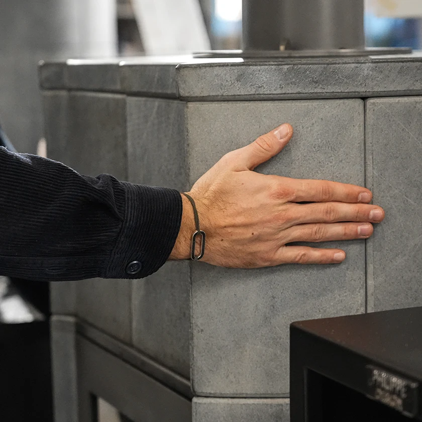 main sur pierre d'un poêle à granulés