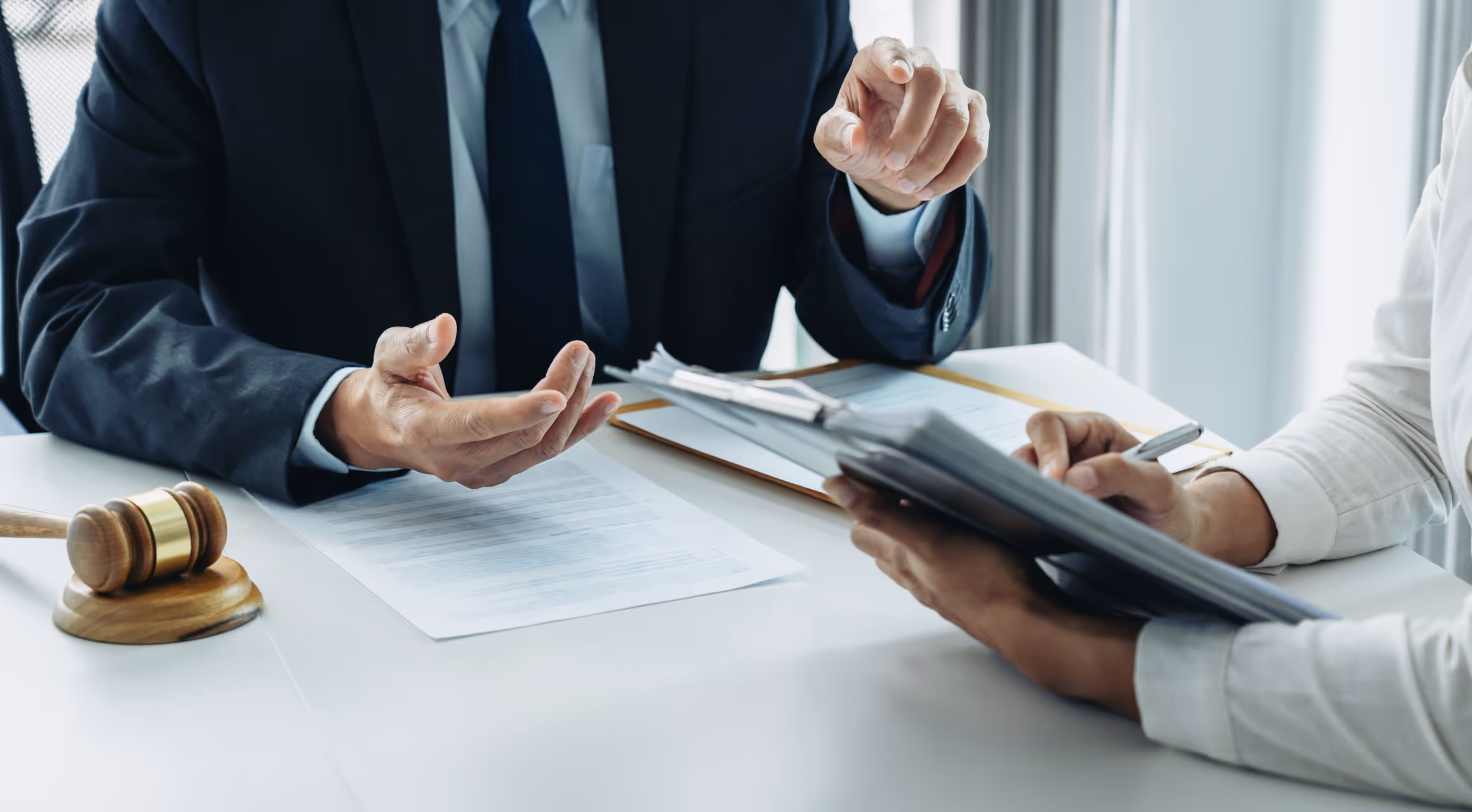 Legal professionals signing an agreement to safeguard client's financial health