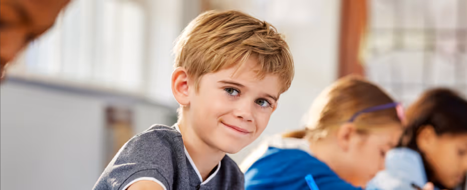 Child smiling while completing the IQ assessment 