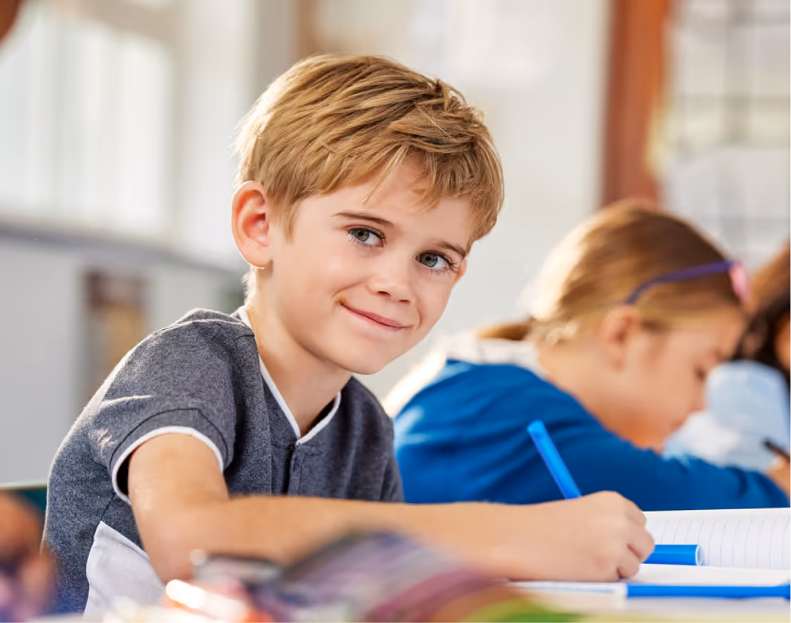 Child smiling while completing the IQ assessment