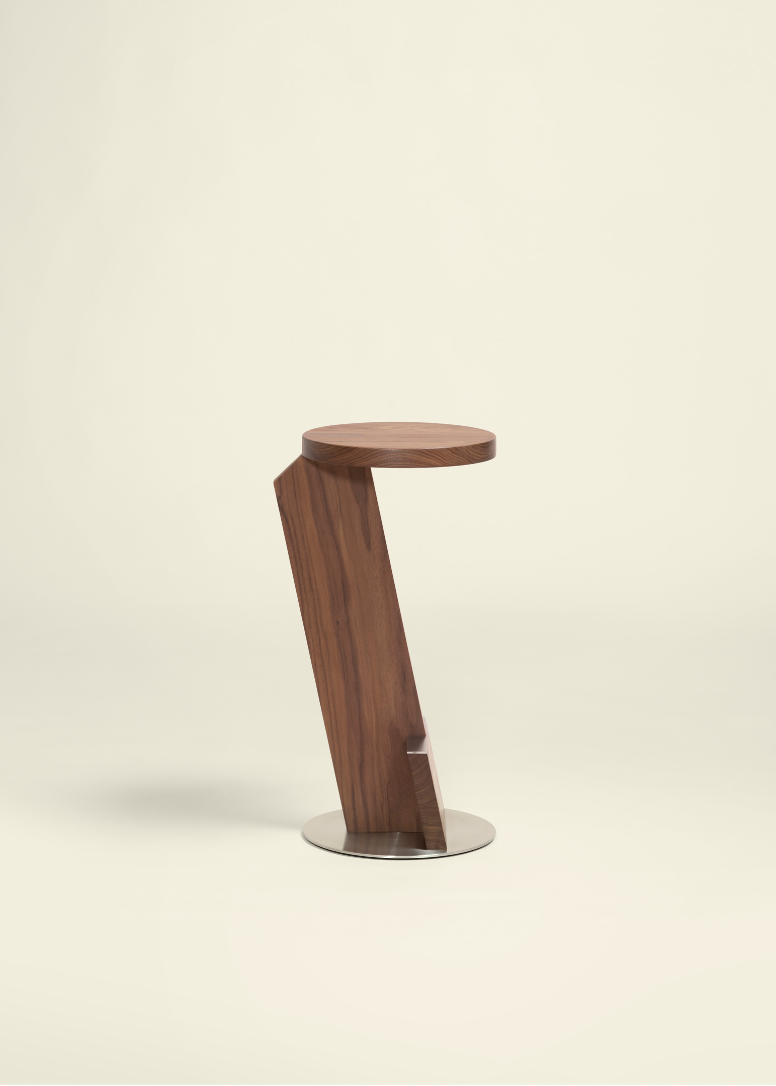 Modern wooden side table with a round top supported by an angled wooden leg and a circular metal base.