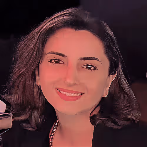 Woman with short dark hair smiling gently against a dark background.
