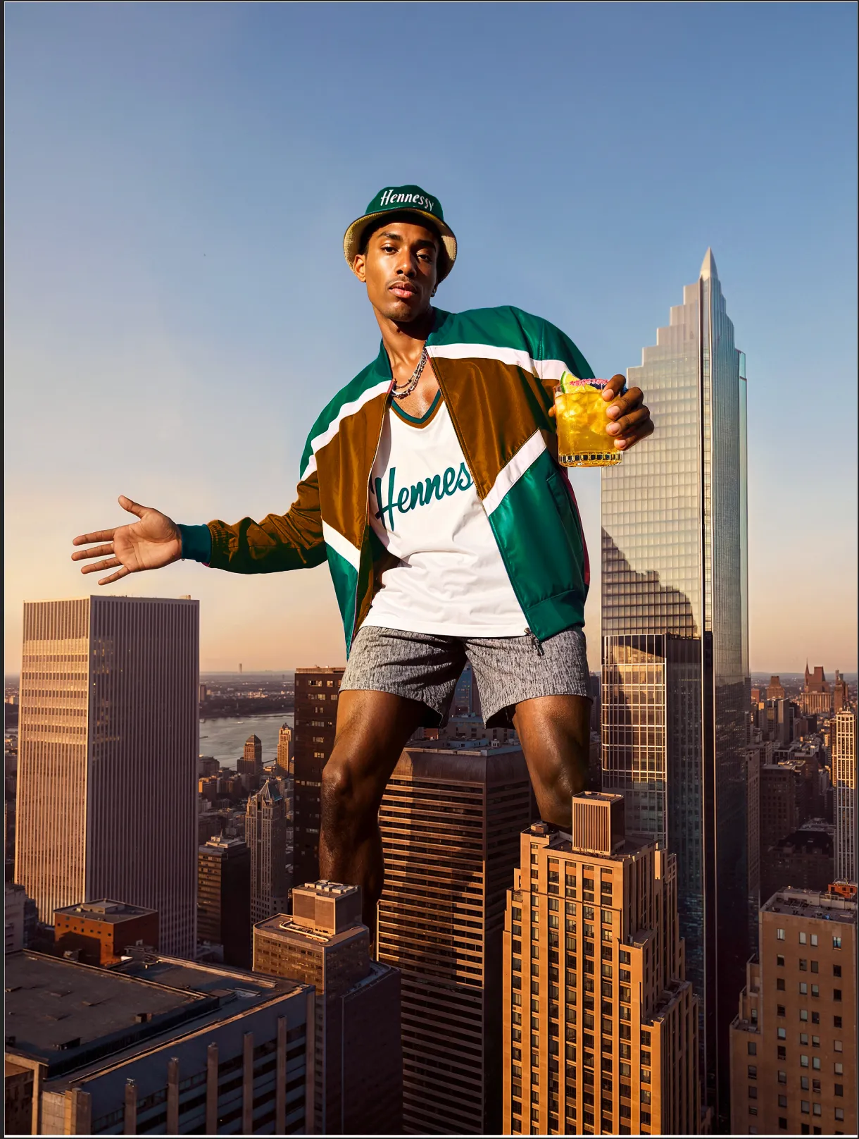 Man sitting on a rooftop ledge above a city skyline, arms raised, holding a Hennessy bottle — ai advertising agency Detroit, photography & art direction by Detroit AI Production House