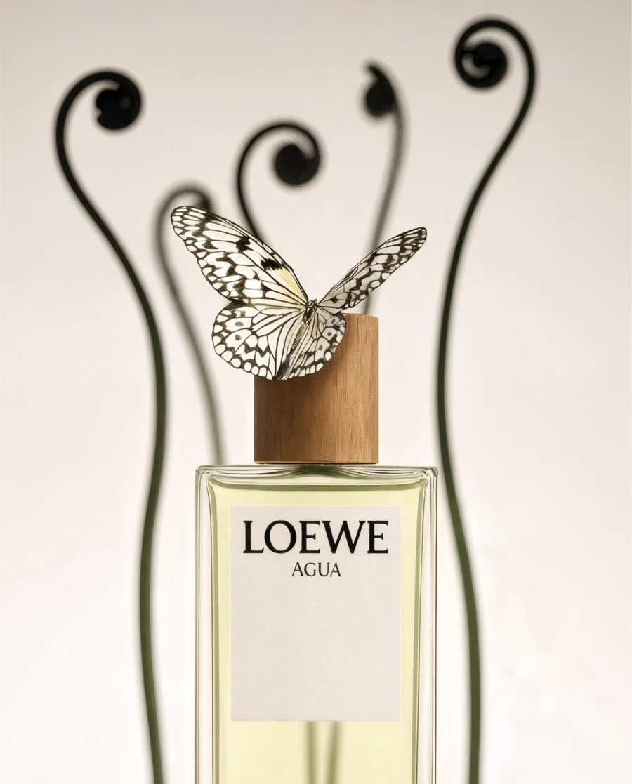 Loewe perfume bottle with sculptural wire butterfly cap detail — AI product advertising photography by SQUAD, Detroit AI Production House