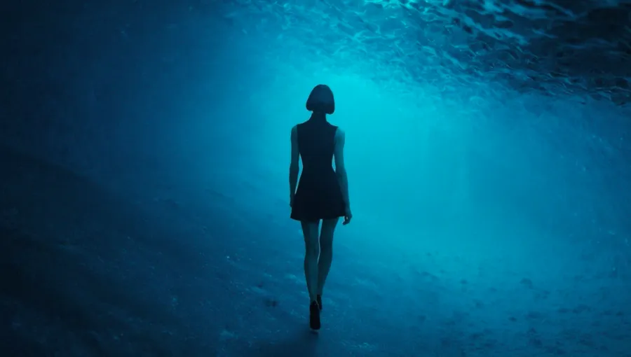 Silhouette of a figure walking underwater lit by blue light — virtual production studio Detroit, image generation & art direction by Pierrick Jégou