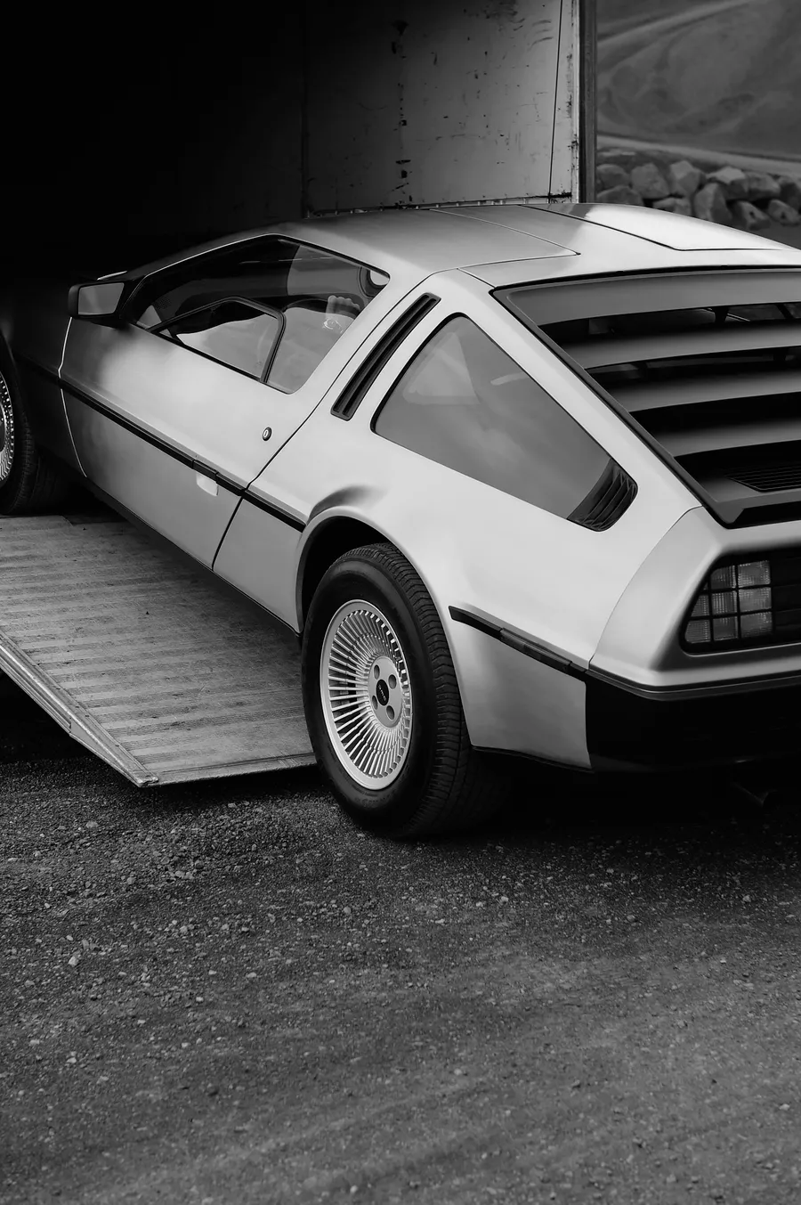 Vintage sports car parked in a garage, black and white — ai advertising agency Detroit, image generation & art direction by Pierrick Jégou