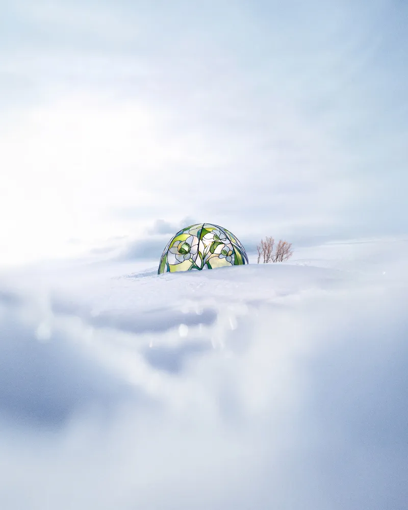 Small stained-glass floral dome half-buried in a vast snowy landscape, Perrier-Jouët Winter campaign — virtual production studio Detroit, photography & art direction by Arnaud