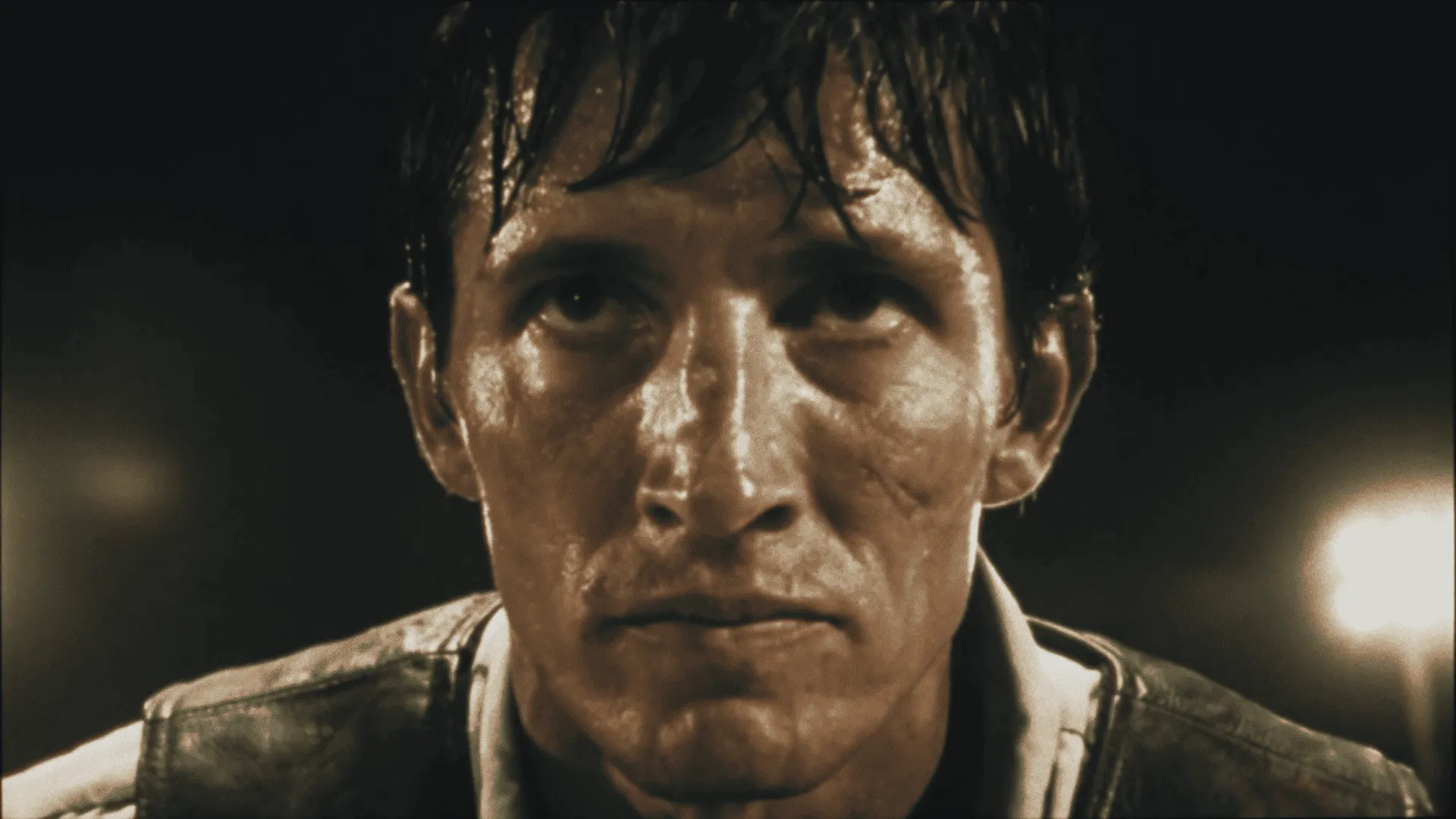 Extreme close-up of a man's face, sweat-soaked and staring intensely under dim light — ai advertising agency Detroit, DOMA manifesto film