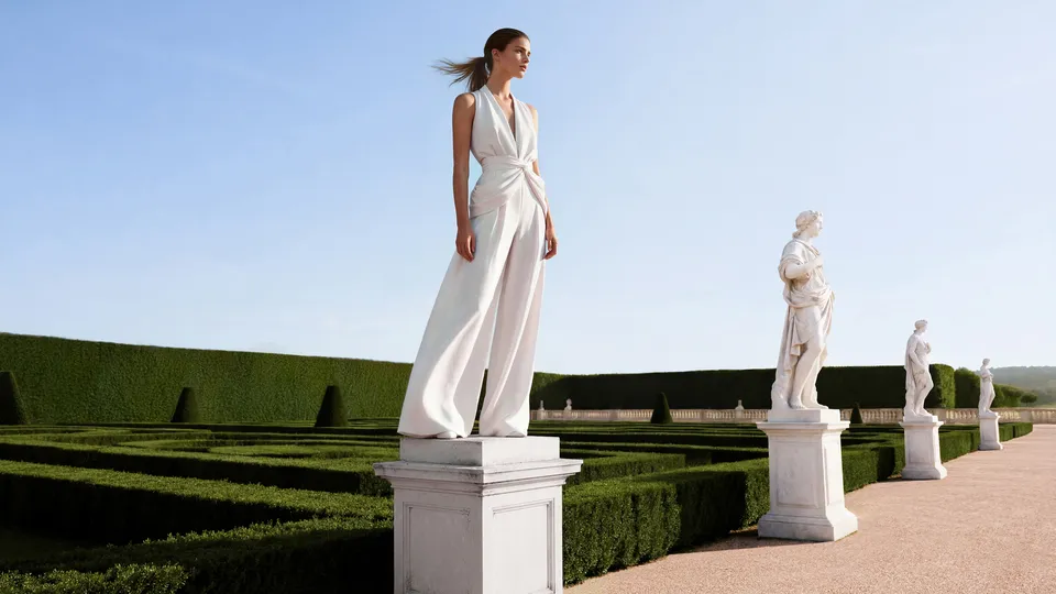 Woman in a white draped gown standing on a pedestal beside classical statues, Parfums de Marly campaign — ai advertising agency Detroit, photography & DA by Alex