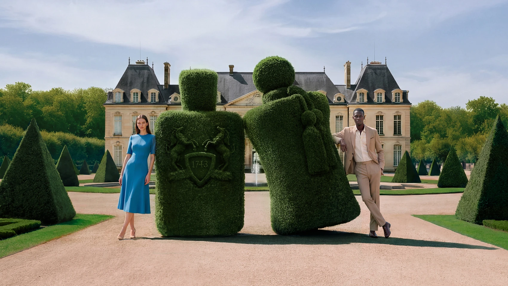 Man and woman standing beside two giant topiary Parfums de Marly bottles before a chateau — 3d product animation Detroit, photography & DA by Alex