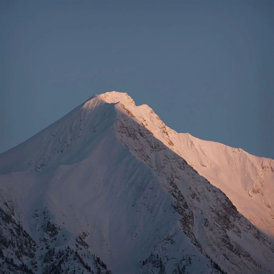 Snow-capped mountain peak glowing pink at sunset against a clear dusk-blue sky for Dom Pérignon Winter — virtual production studio Detroit, photography & art direction by Pierrick Jégou