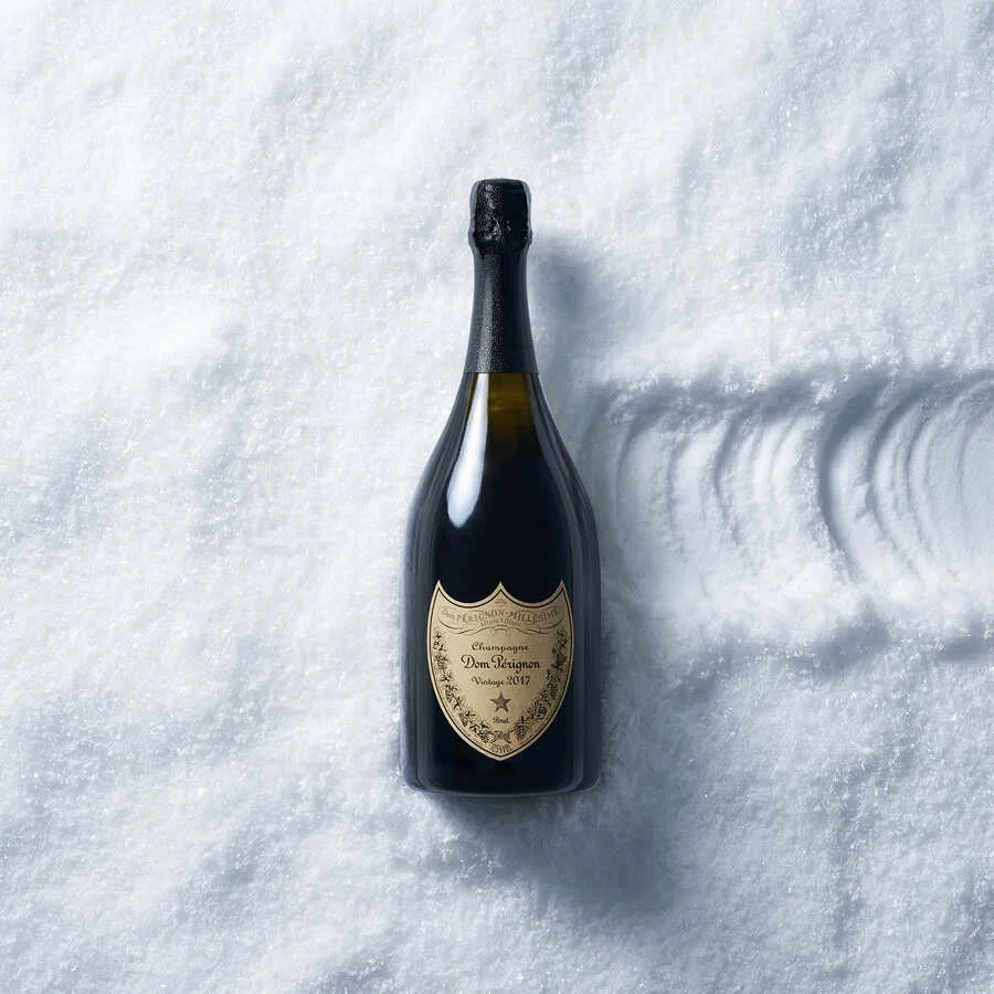 Dom Pérignon bottle lying on its side in snow, viewed from above with the label facing the camera — 3d product animation Detroit, photography & art direction by Pierrick Jégou