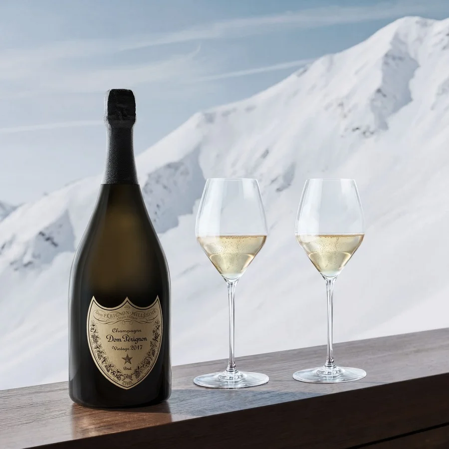 Dom Pérignon Vintage 2017 bottle beside two filled champagne glasses on a wooden ledge overlooking snowy peaks — 3d product visualization Detroit, photography & art direction by Pierrick Jégou
