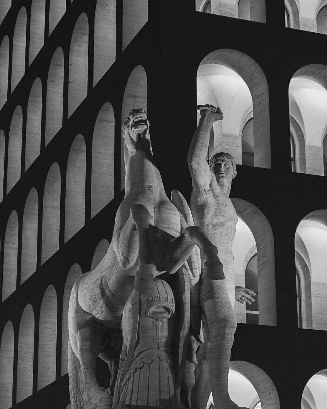 Marble statue of a rearing horse and a raised-arm figure set against a geometric arched stone facade — cgi studio Detroit, from Detroit's copyright law report