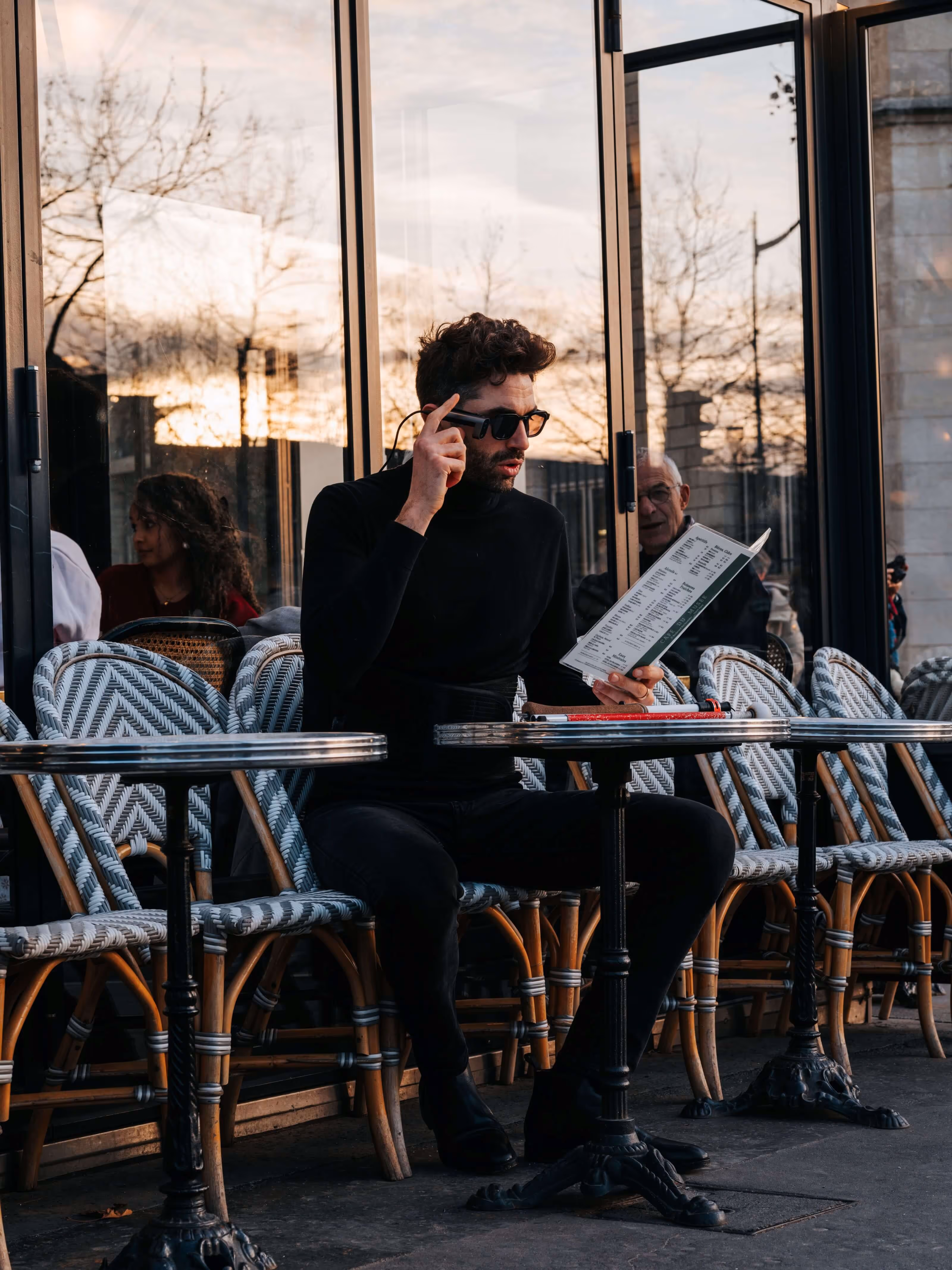 Un homme lit un menu à la terrasse d’un café à l’aide du dispositif SeeHaptic.
L’intelligence artificielle embarquée dans la caméra transforme le contenu visuel en information accessible.