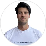 Portrait of a man with dark hair wearing a white shirt against a white background.