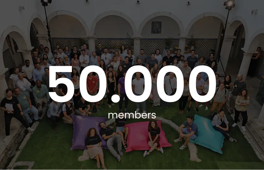 Group of diverse people gathered in a courtyard with text overlay '50,000 members'.