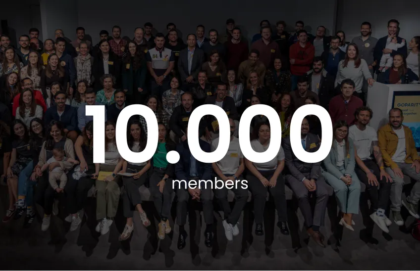 Large diverse group of people posing together with text overlay '10,000 members'.