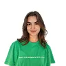 Smiling woman with long brown hair wearing a green T-shirt against a white background.