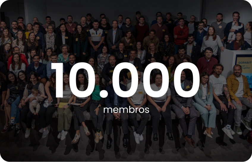 Large diverse group of people posing together with text overlay '10,000 members'.