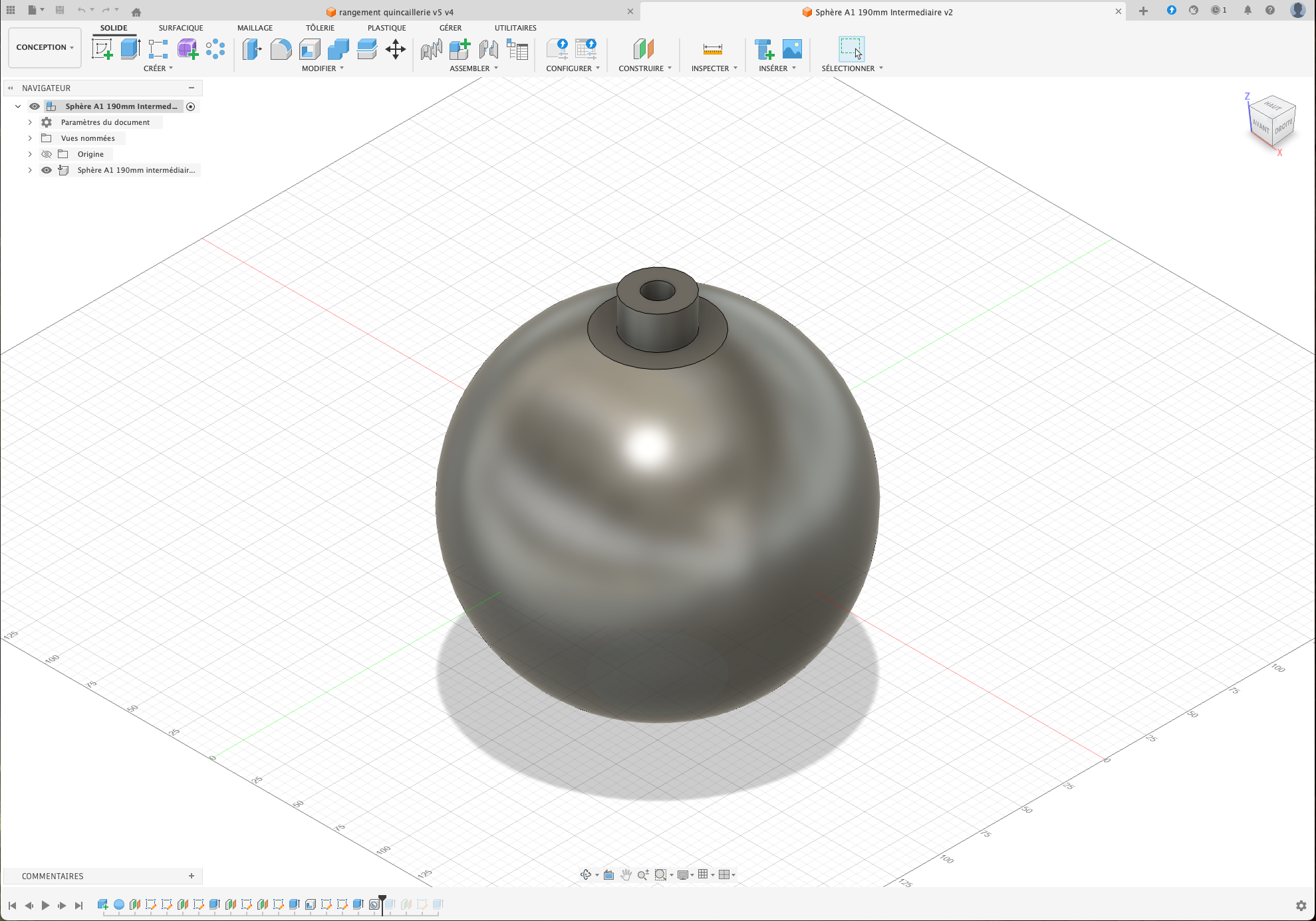 3D CAD model of a metallic sphere with a small cylindrical protrusion on top, displayed on a grid workspace.