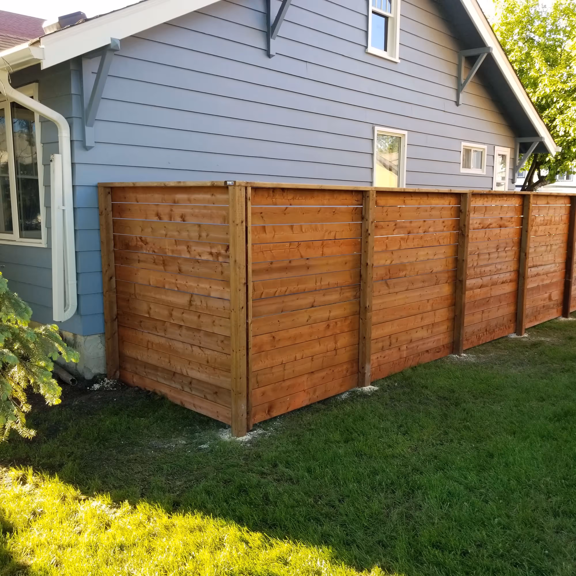 New backyard fence installation project with pressure-treated wood at low maintenance cost for residential properties in the Winnipeg area.