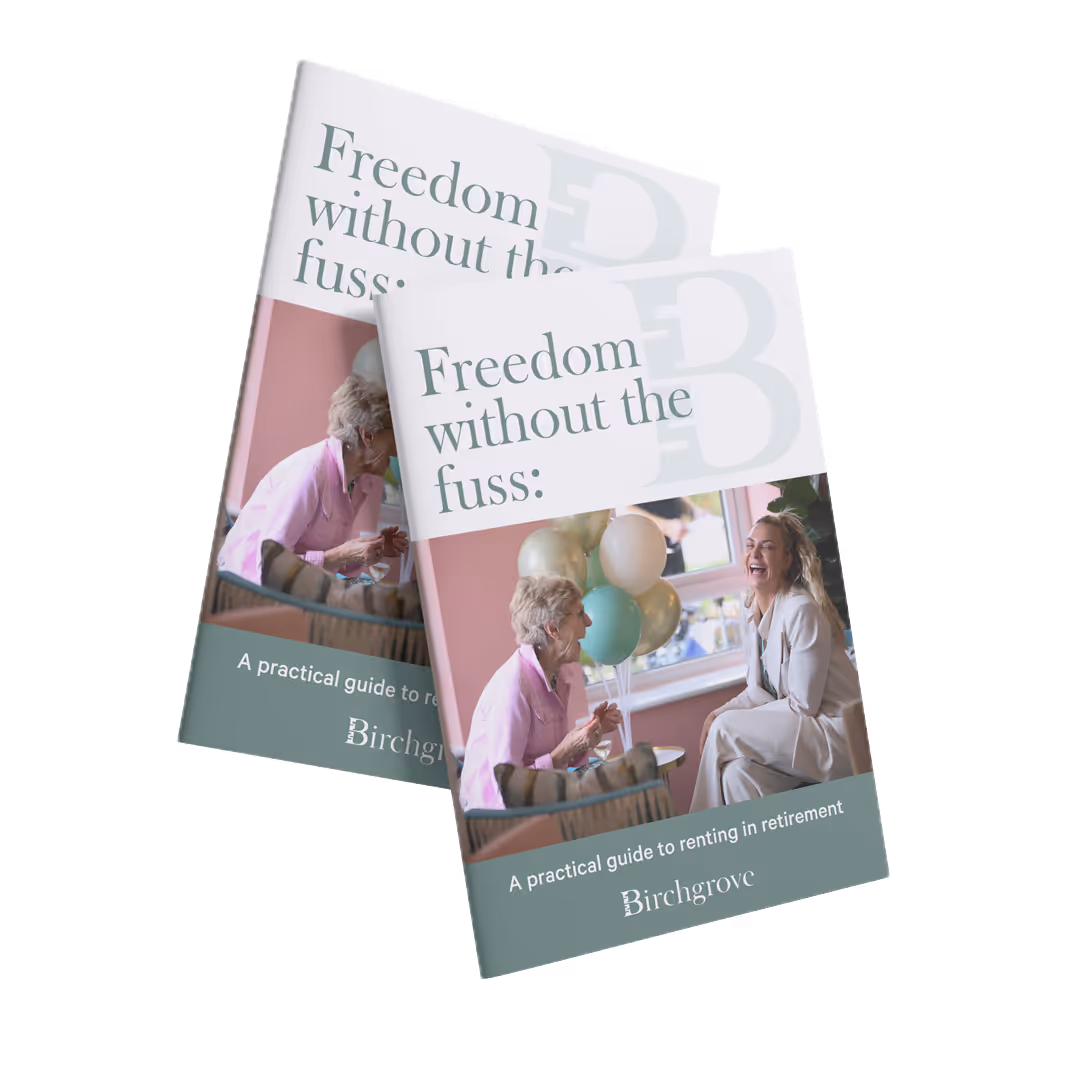 Cover of a guide titled 'Freedom without the fuss: A practical guide to renting in retirement' featuring two women, one elderly and one younger, smiling and talking indoors with balloons in the background.