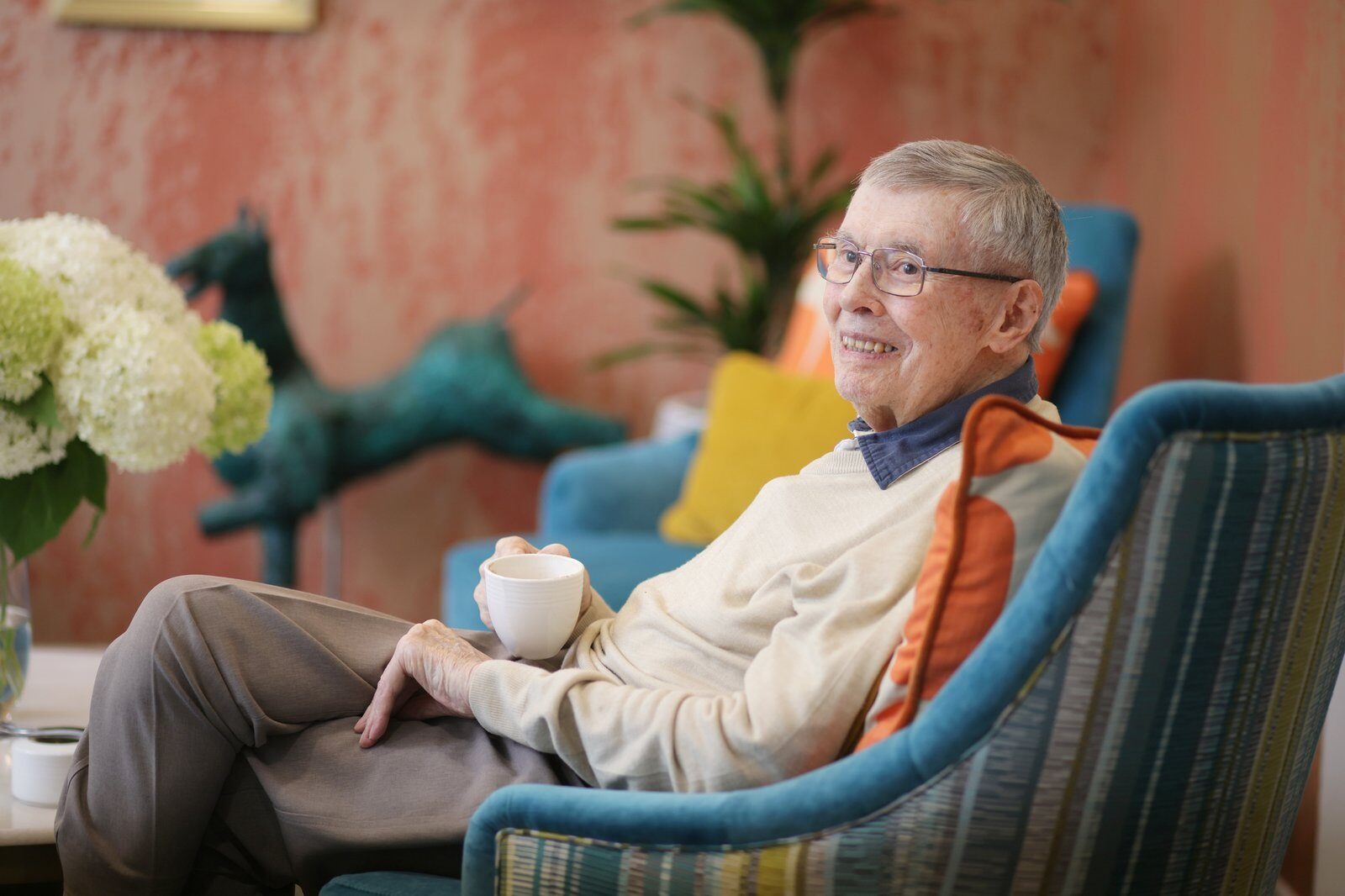 A neighbour having a quiet moment with a cup of tea in a welcoming neighbourhood setting at Birchgrove.