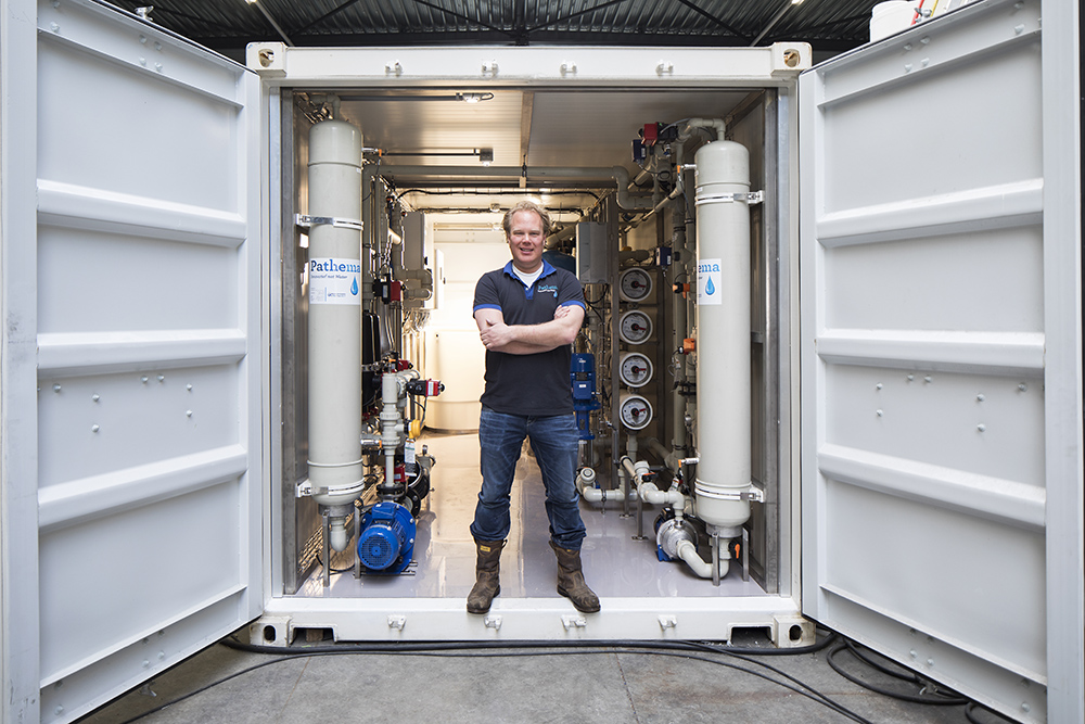 Mark Boeren, CEO of Pathema, in front of the installation at Amgen