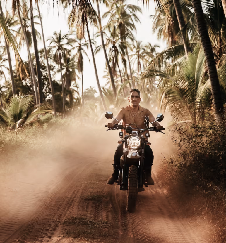 Andrés Saavedra, founder of AS.D, riding through the palms in Guerrero