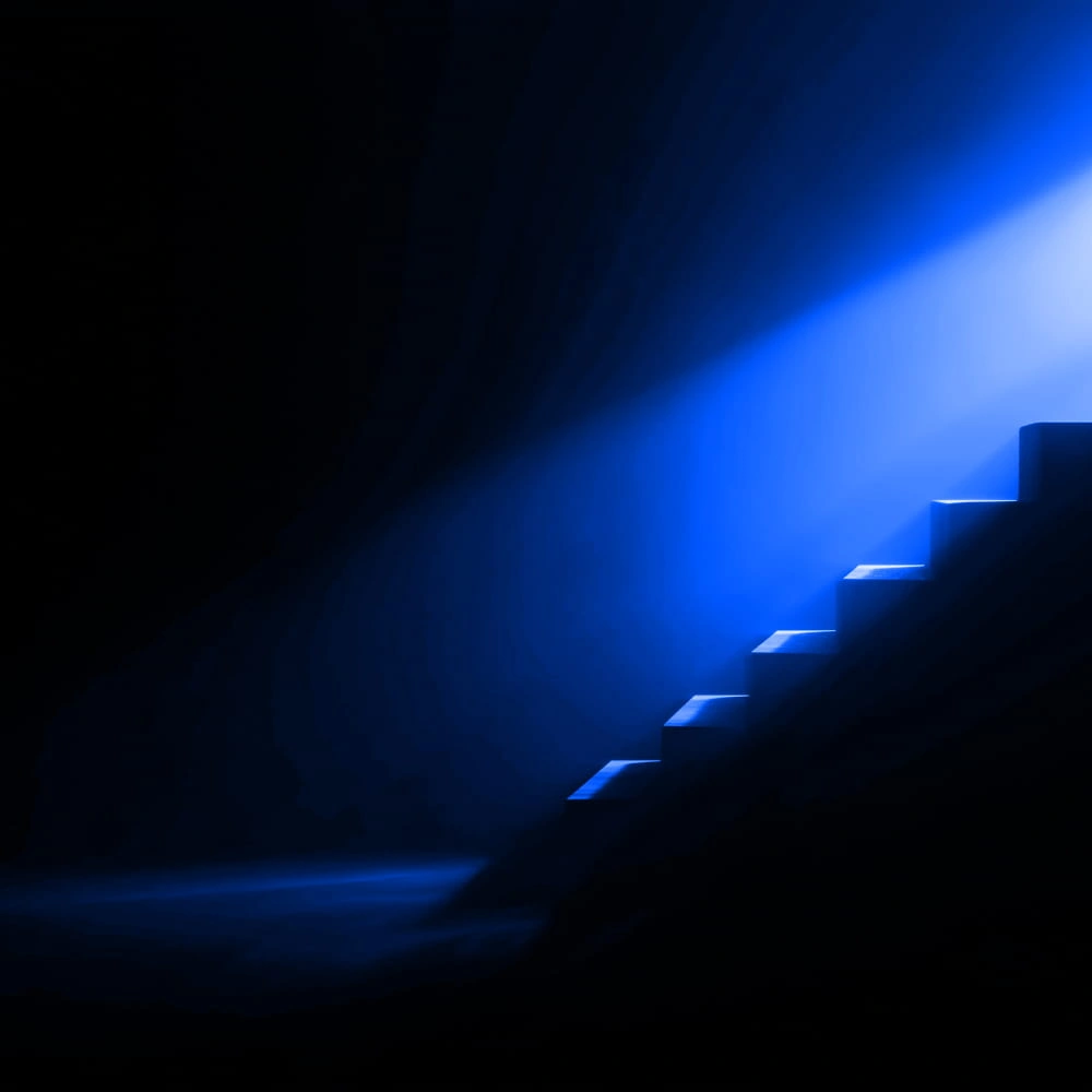 Abstract blue light shining on dark stairs