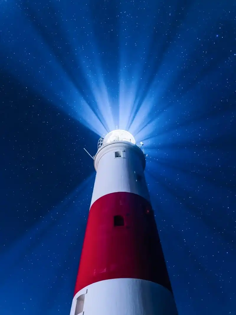 A red and white lighthouse, symbolizing Molfar Intelligence’s commitment to providing clear guidance and undeniable truth in complex informational landscapes