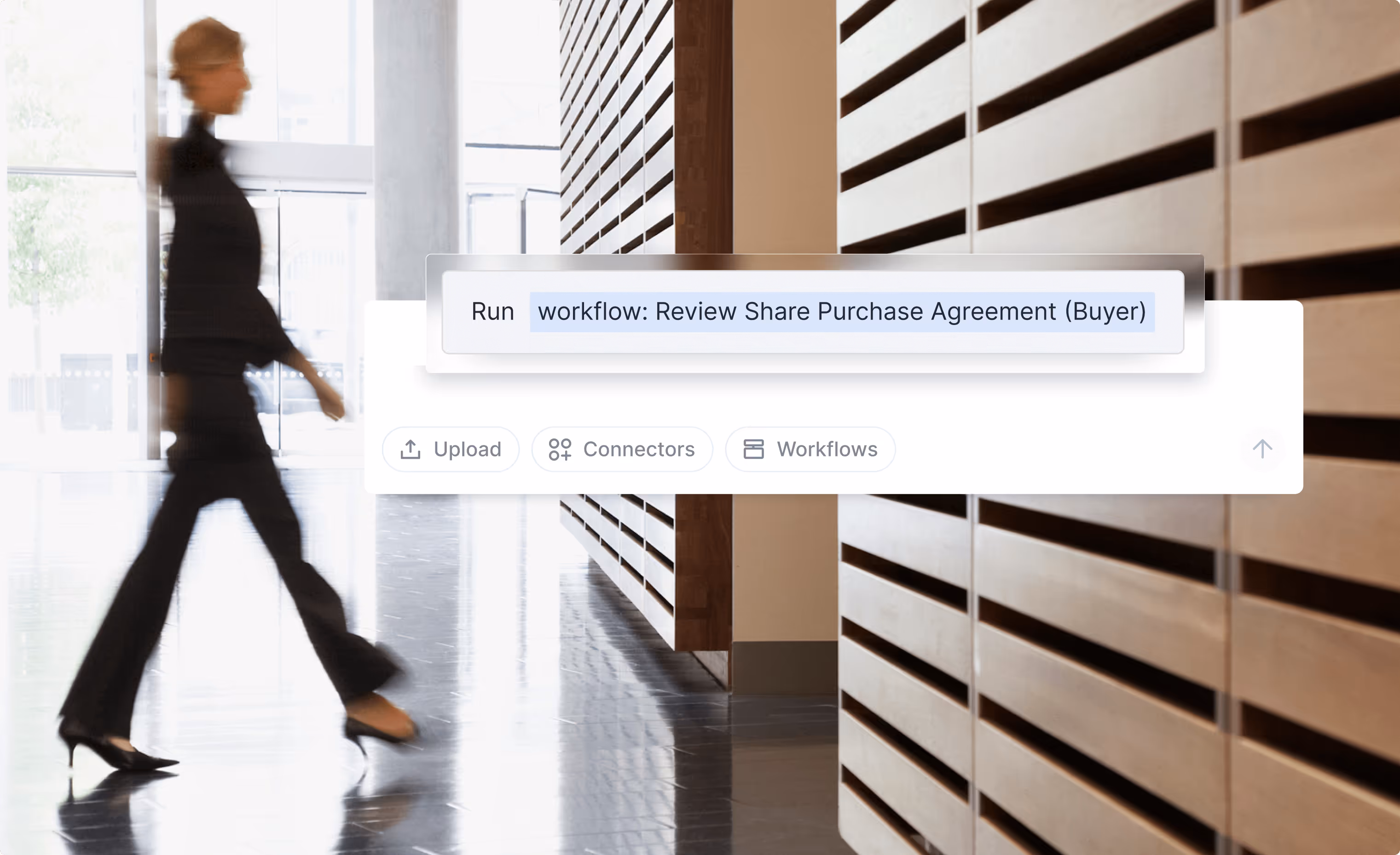 Blurred woman walking in a modern office hallway with an overlay showing a digital interface to run the workflow 'Review Share Purchase Agreement (Buyer)'.