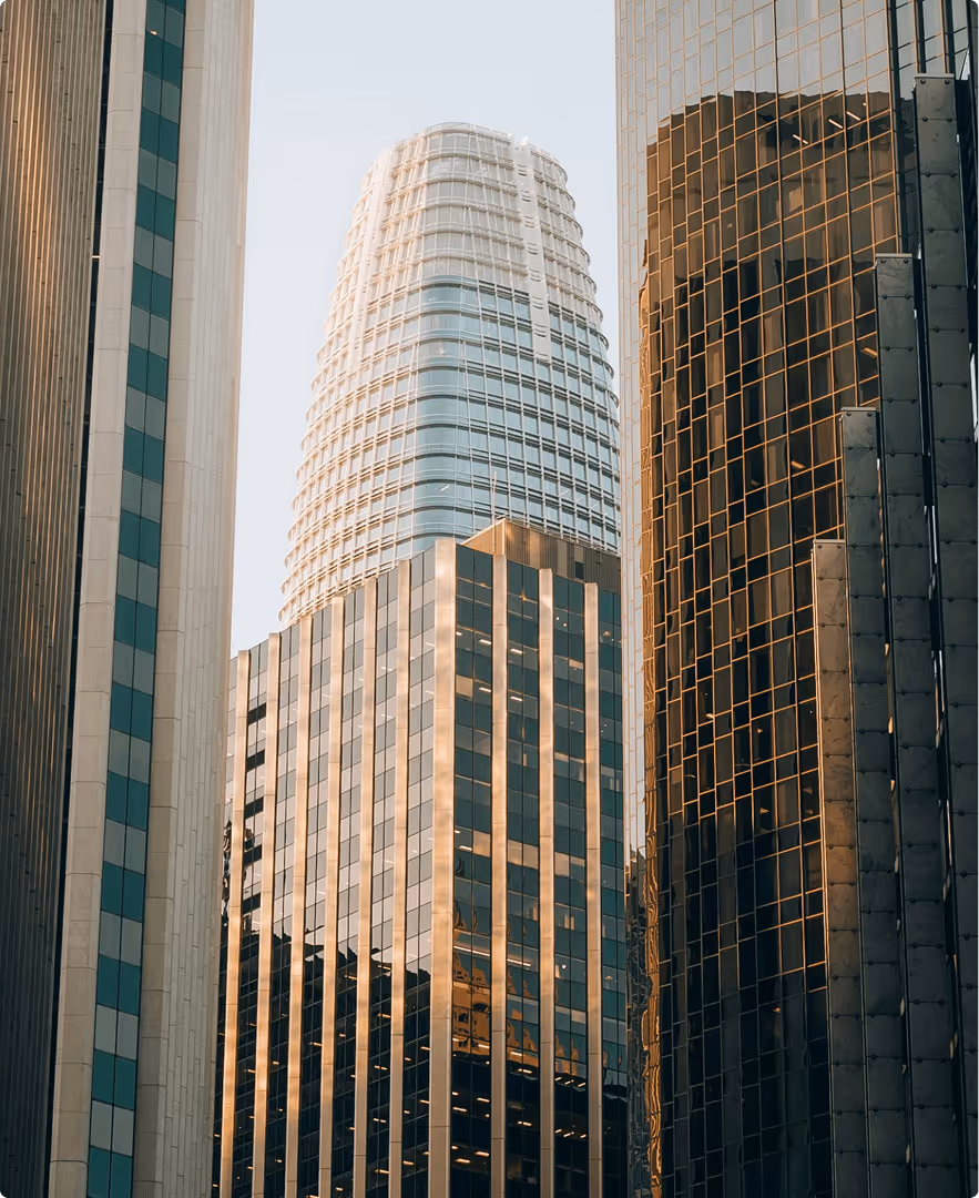 Modern skyscrapers with reflective glass facades under clear sky.
