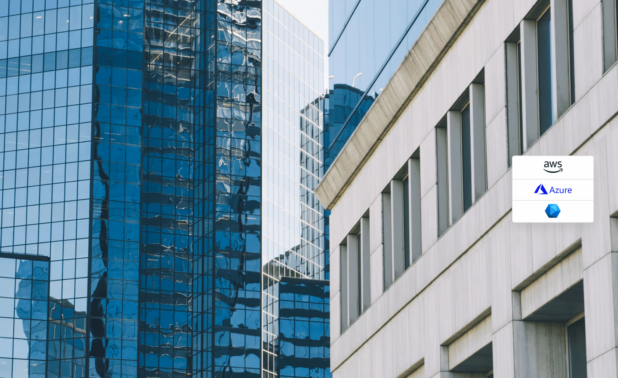 Modern glass skyscrapers reflecting each other beside a concrete office building with cloud service icons for AWS, Azure, and IBM Cloud overlayed.
